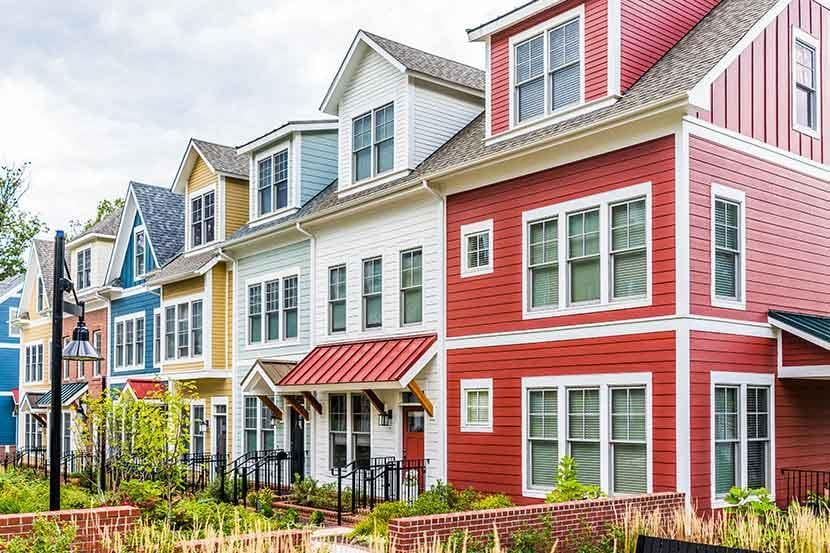 row of colorful red yellow blue white green painted townhouses