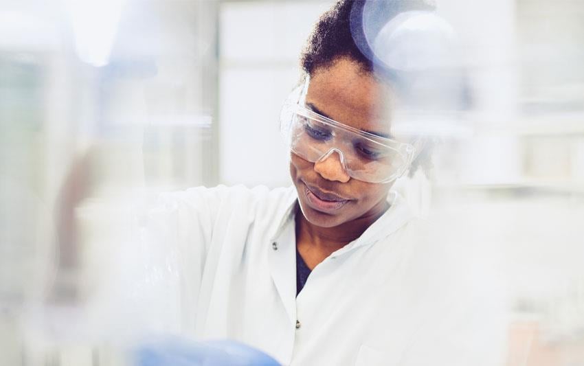 Scientist wearing safety googles working in a lab